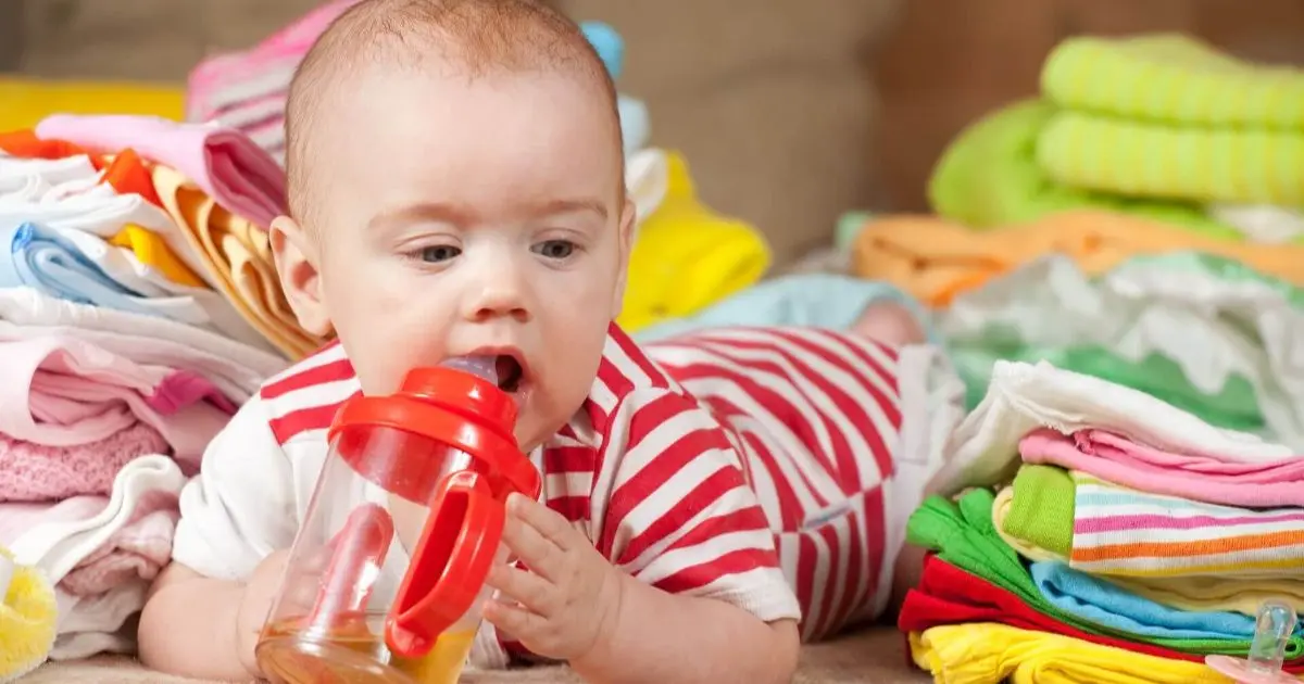 Baby Essentials: baby girl surrounded by essential baby items, highlighting everyday newborn care products parents rely on