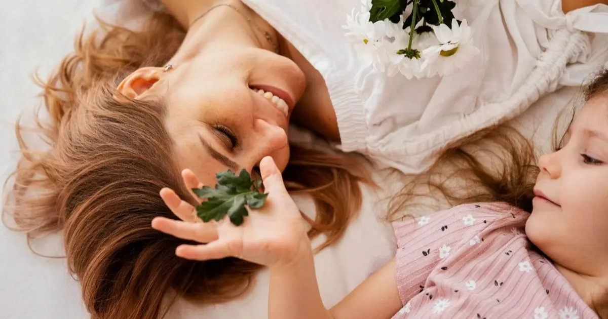 Perfect Mother – a beautiful mother and daughter holding a bouquet of delicate spring flowers, capturing a soft, loving moment filled with tenderness and connection.