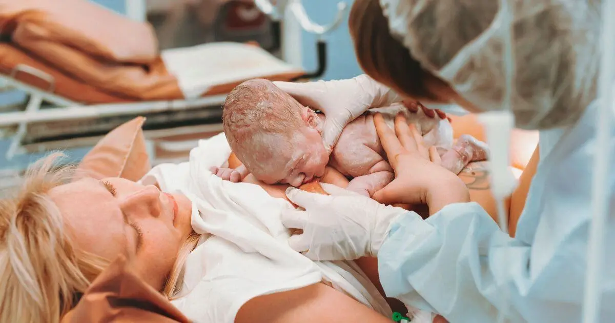 newborn baby placed on mother’s chest immediately after childbirth in hospital