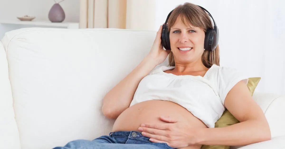 Trying to Conceive? What Really Matters Before You Get Pregnant Pregnancy After 40 lifestyle image of a relaxed pregnant woman listening to music while resting comfortably at home.