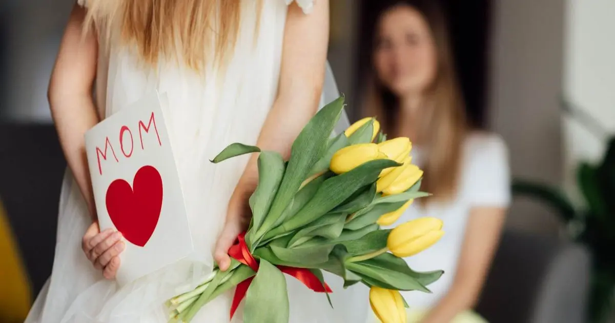 Perfect Mother – close-up of a woman holding flowers, capturing a soft, natural moment of calm, femininity, and gentle motherhood.
