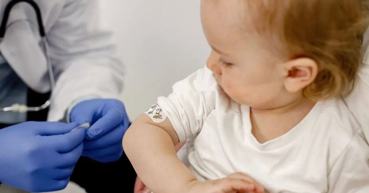 Infant vaccinations – cropped photo of a young boy’s shoulder with a bandage after receiving a vaccination