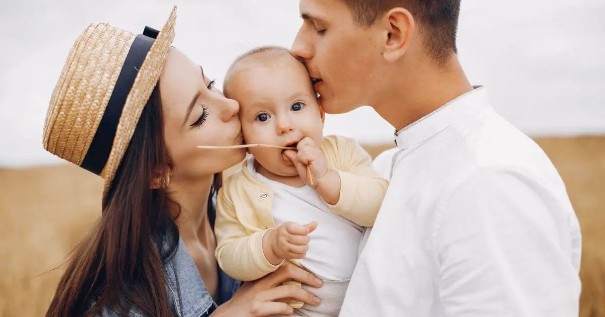 Gentle Parenting: A cute family playing together in an autumn field, enjoying warm colors, laughter, and joyful moments outdoors.