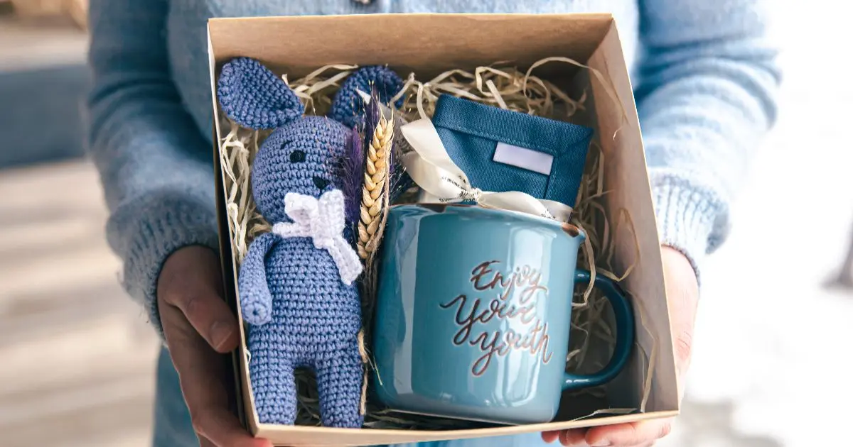 Mother’s Day gift box with baby items and mug, thoughtful and practical gift idea for new moms