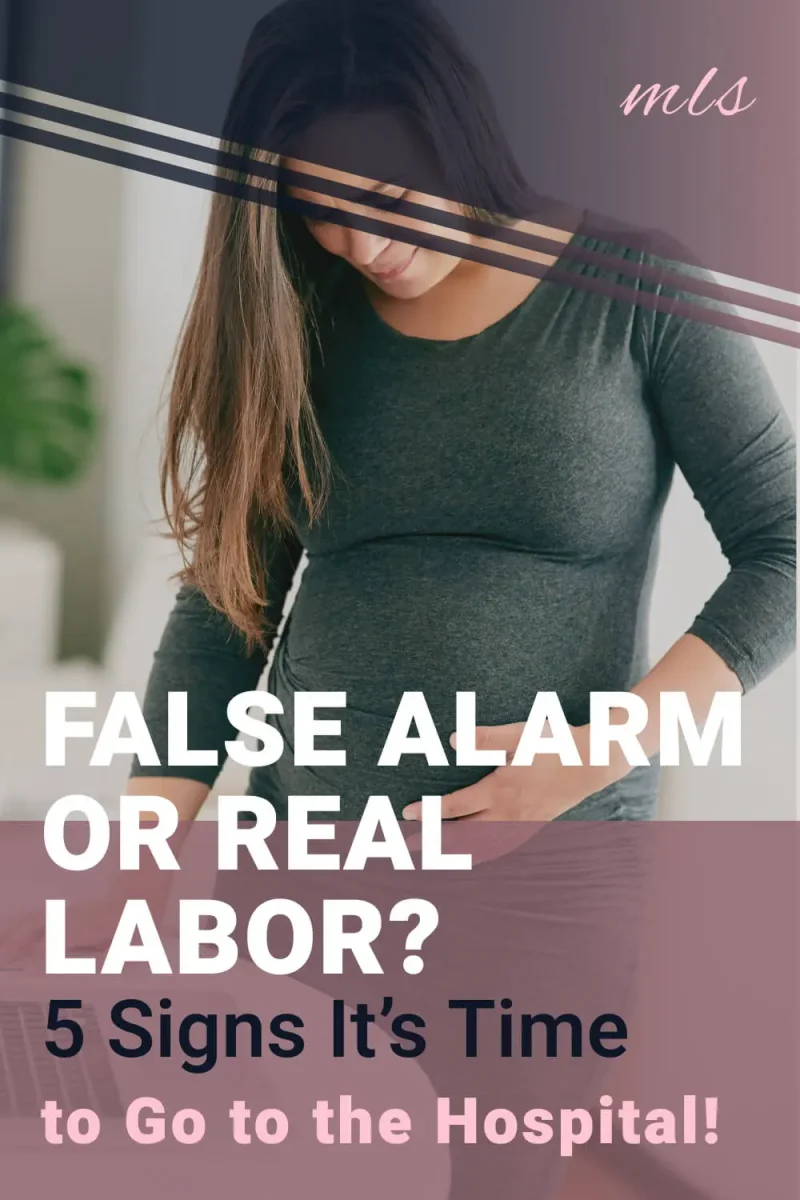 Pregnant woman holding her baby bump while experiencing possible labor contractions, with signs that help identify the difference between false labor and real labor before going to the hospital.