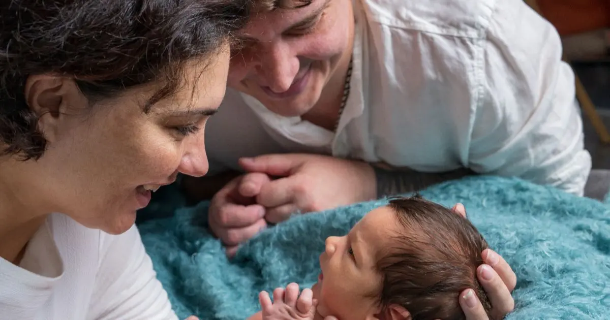 Baby Visitors sharing tender first moments with newborn and parents