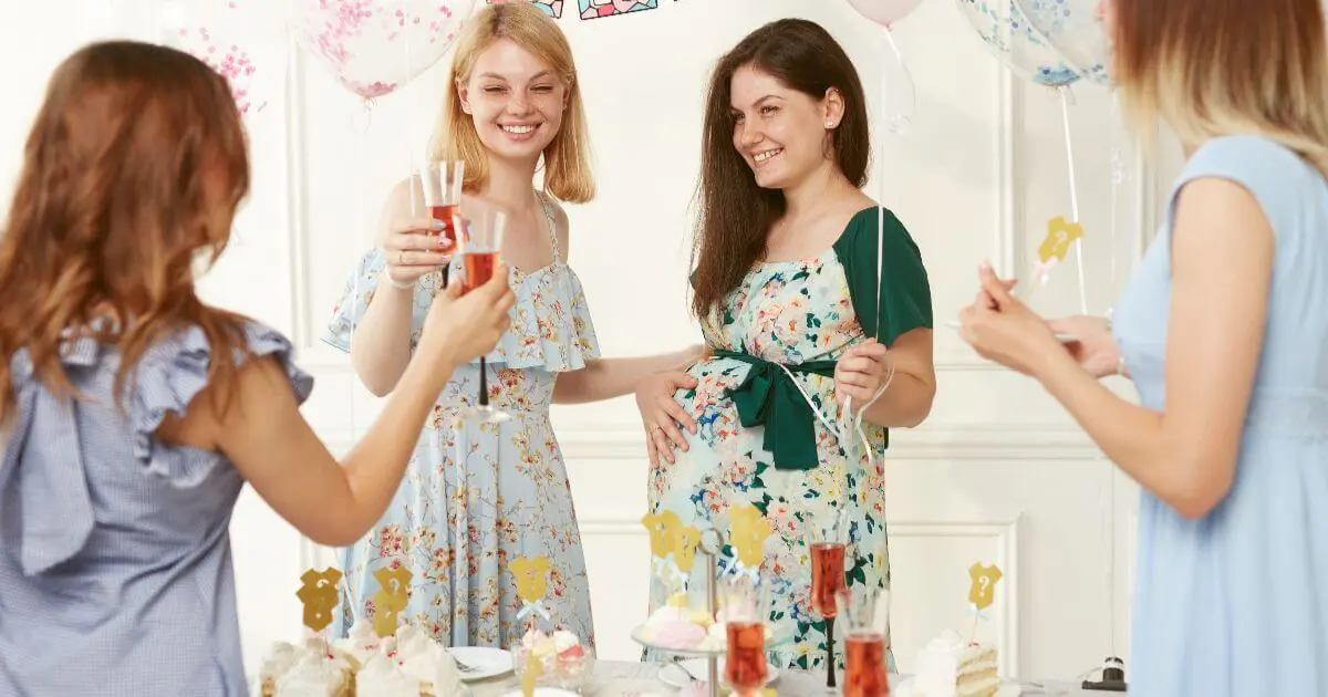 Expectant mother celebrating at a gender reveal party with friends, balloons, drinks, and festive decorations before revealing whether she's having a baby boy or girl.