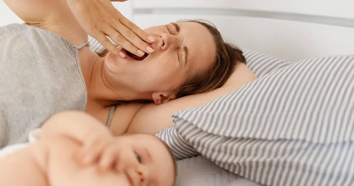 5 Postpartum Truths No One Warns You About sleep deprivation sleepy mother lying in bed with infant baby after a sleepless night