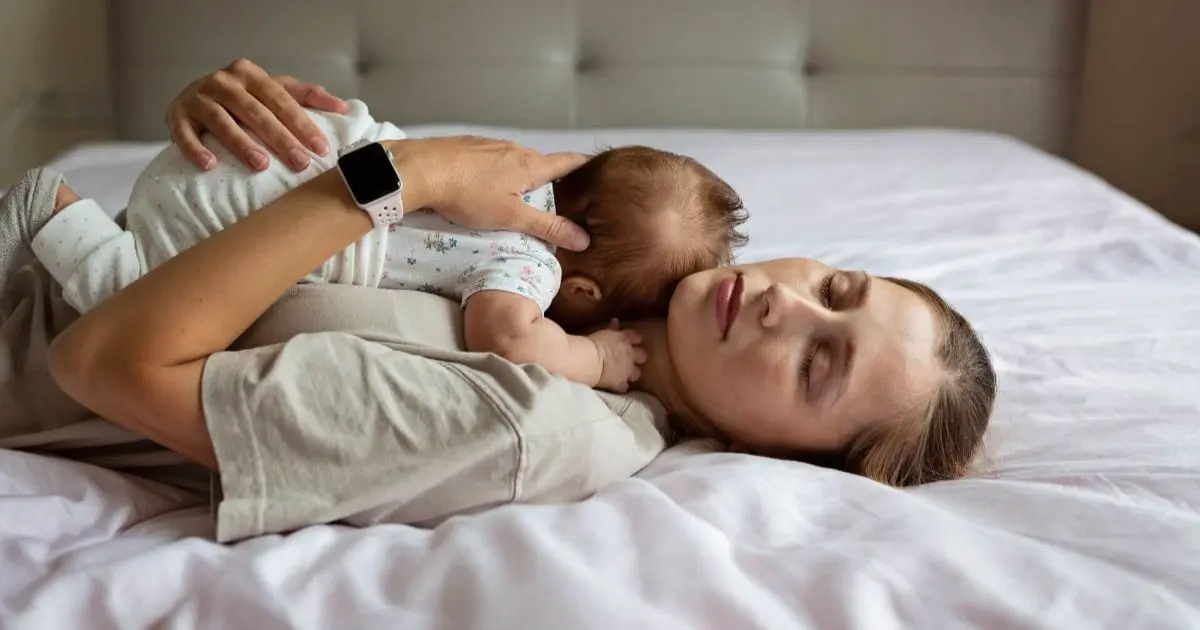 sleep deprivation tired parent awake at night with baby under dim light