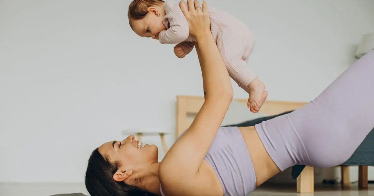 Postpartum Recovery showing a mother doing gentle postpartum exercises while playing with her baby, supporting safe recovery and rebuilding strength after childbirth.