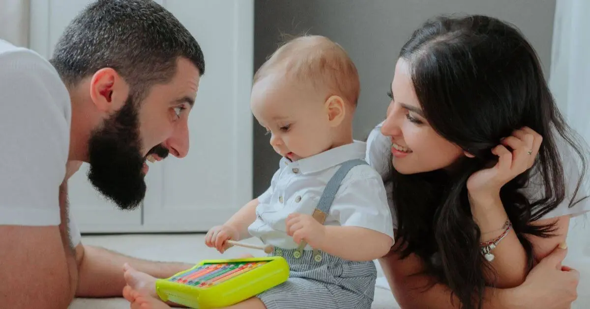 Gentle Parenting in Real Life – parents playing with their child on the floor, creating a safe, playful environment that supports bonding, trust, and emotional development.