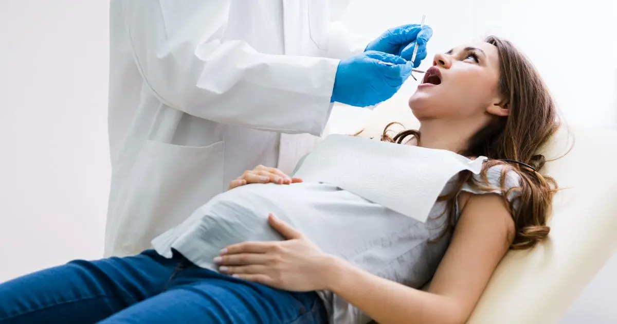 Pregnancy myths – pregnant woman at the dentist during a dental checkup while expecting a baby