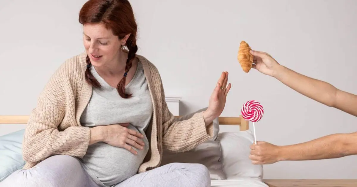 Pregnancy Isn’t Always Pink: 5 Things No One Tells You (But Should) A pregnant woman gently refusing snacks, highlighting mindful eating and personal comfort during