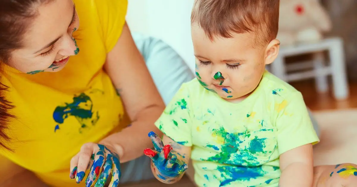 What to Watch for During Summer? Sensory Activities Toddlers and Babies Love (0–12 Months) Toddler and mother exploring colorful messy paint play together, encouraging creativity, touch, and early learning through sensory activities toddlers and babies enjoy at home.