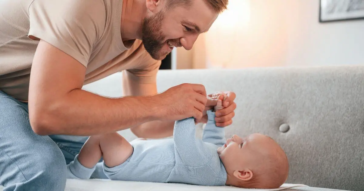 Father’s Day newborn care moment with father changing and caring for his baby at home