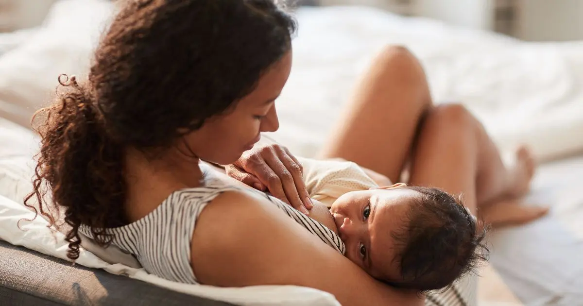 The Truth About Breastfeeding: The Pain, the Tears, and the Tiny Victories Breastfeeding mother holding newborn baby while nursing at home in a calm, natural moment