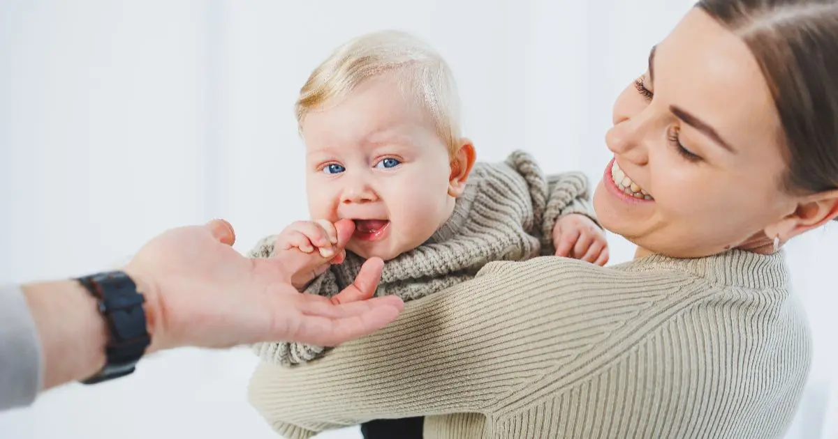 Mother holding a high needs baby who prefers constant closeness and emotional reassurance, showing strong attachment and sensitive baby temperament.